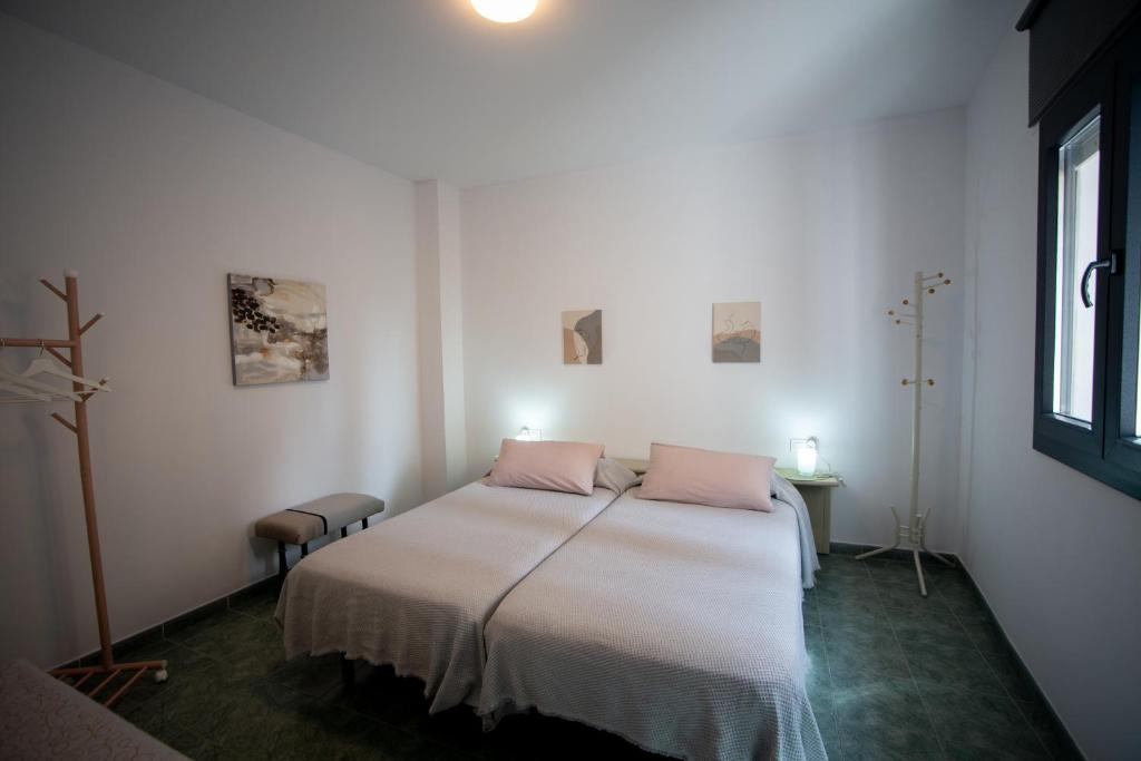 Un dormitorio con una cama con almohadas rosas. en Casa Ángeles en Teruel