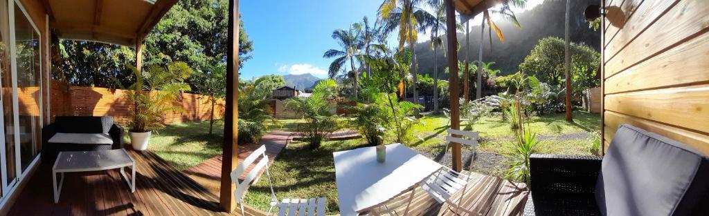 a view of a garden with trees and a fence at Bunga-lodge VANILLE in Saint-André