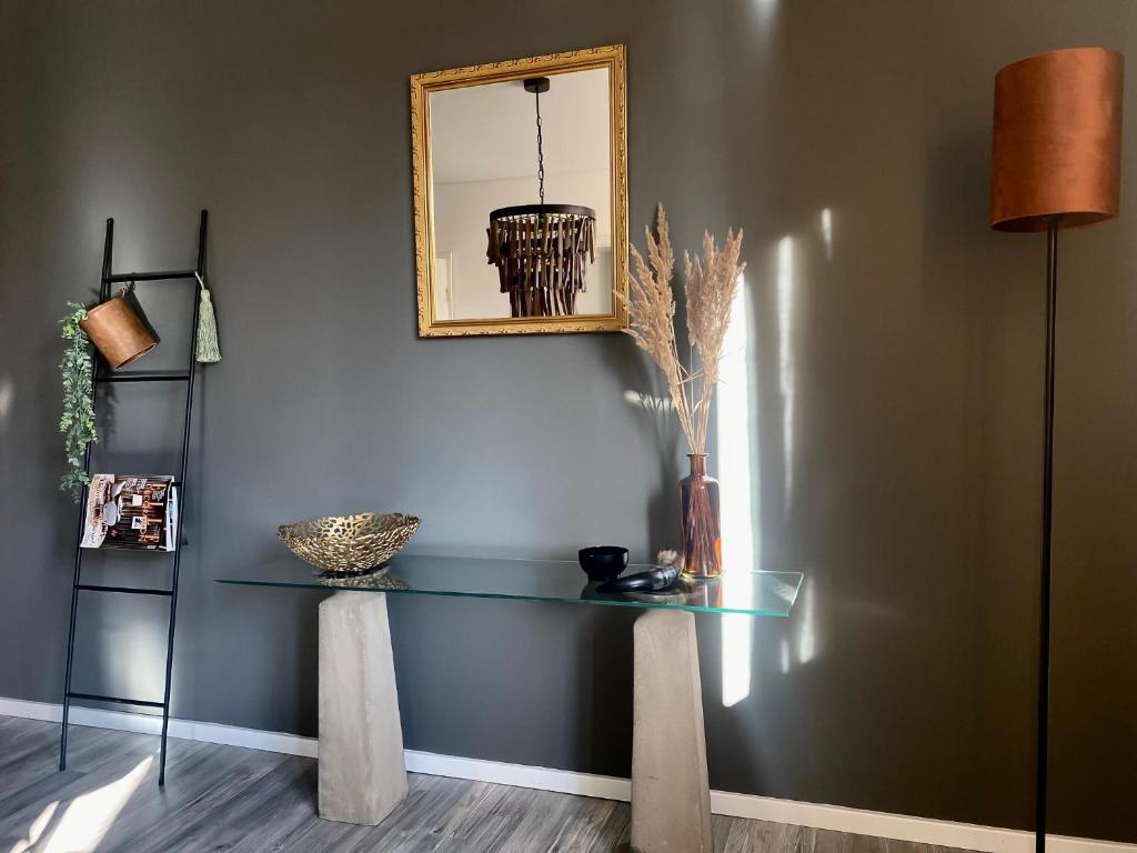 a table with a mirror on a wall at Olivia in Tholey