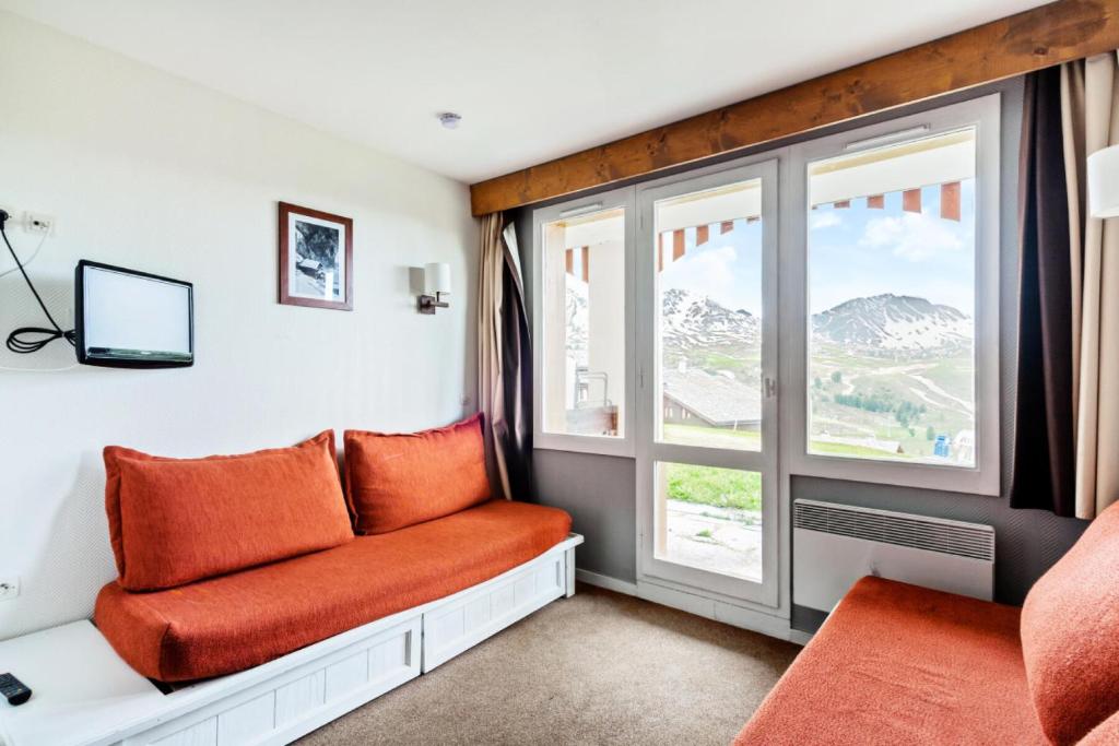 un salon avec un canapé et une fenêtre dans l'établissement Résidence Les Constellations - maeva Home - Studio 5 Personnes Sélection MAE-3766, à La Plagne Tarentaise