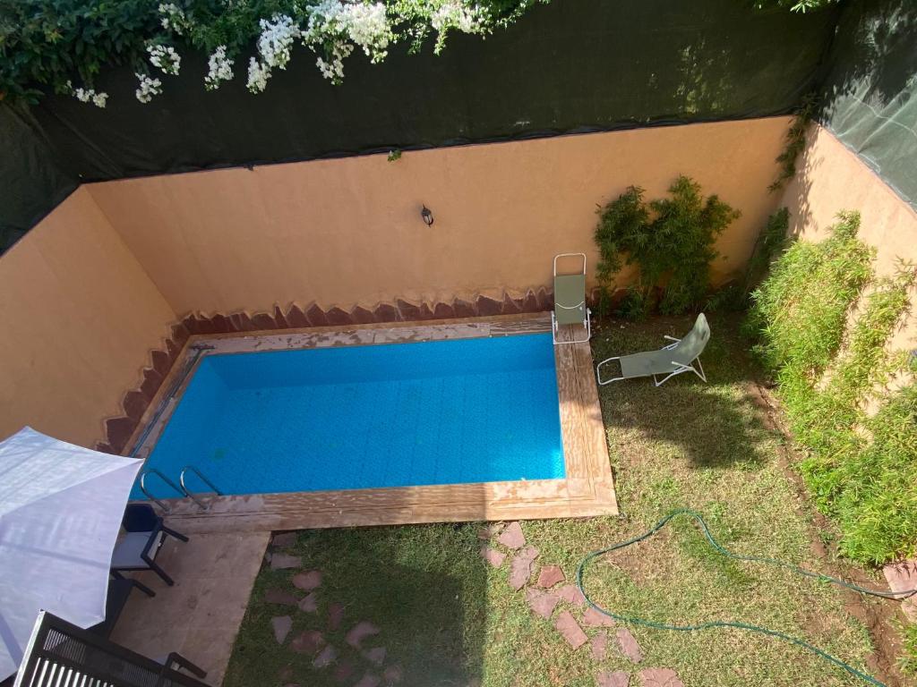 an overhead view of a swimming pool with an umbrella at Villa Targa in Marrakesh