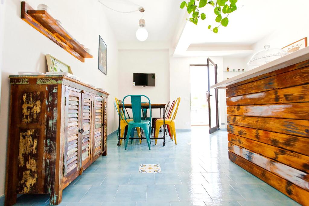 a dining room with wooden furniture and a table at B&B Shining in Avola