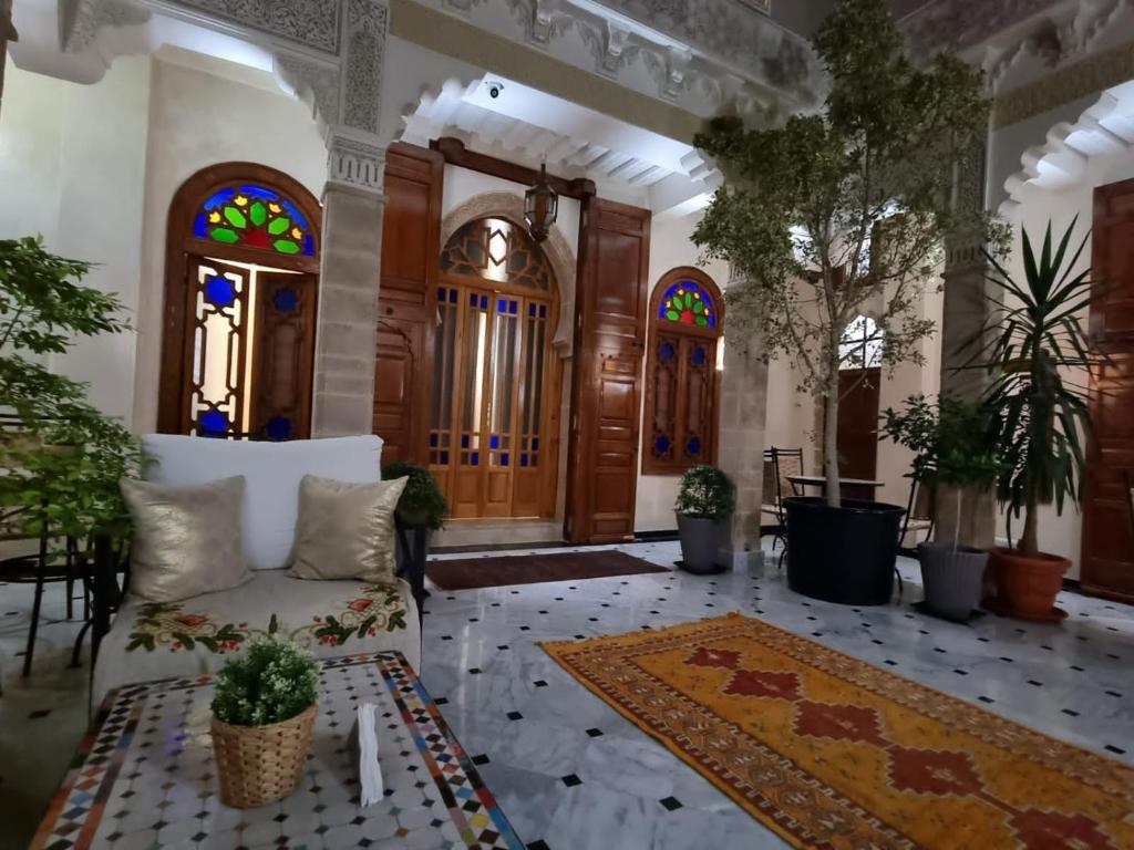 a living room with a couch and stained glass windows at RIAD LALLA ZINEB in Rabat