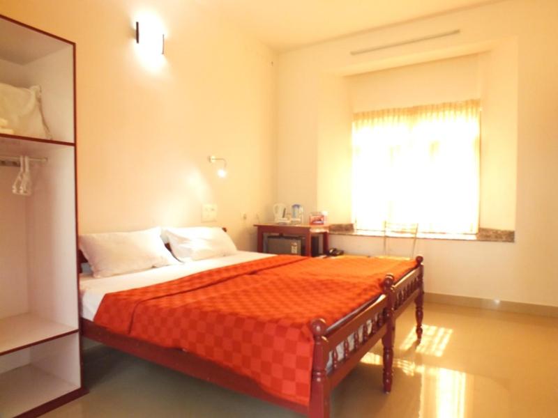 Postel nebo postele na pokoji v ubytování Cherai Beach Residency