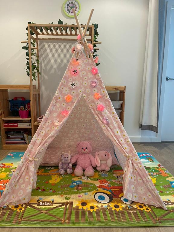 a group of stuffed teddy bears in a play tent at Glenelg resort style beachside apartment in Glenelg