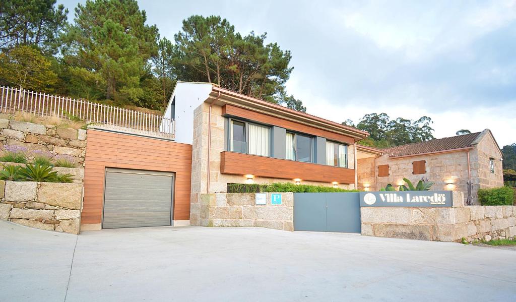 a house with a garage in front of it at VILLA LAREDO *** in Armentera
