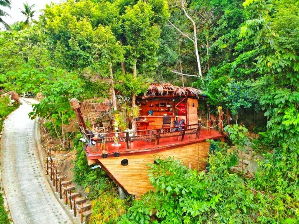a small boat on a track in a forest at Sea View Palm Villa - Tree House in Haad Yao