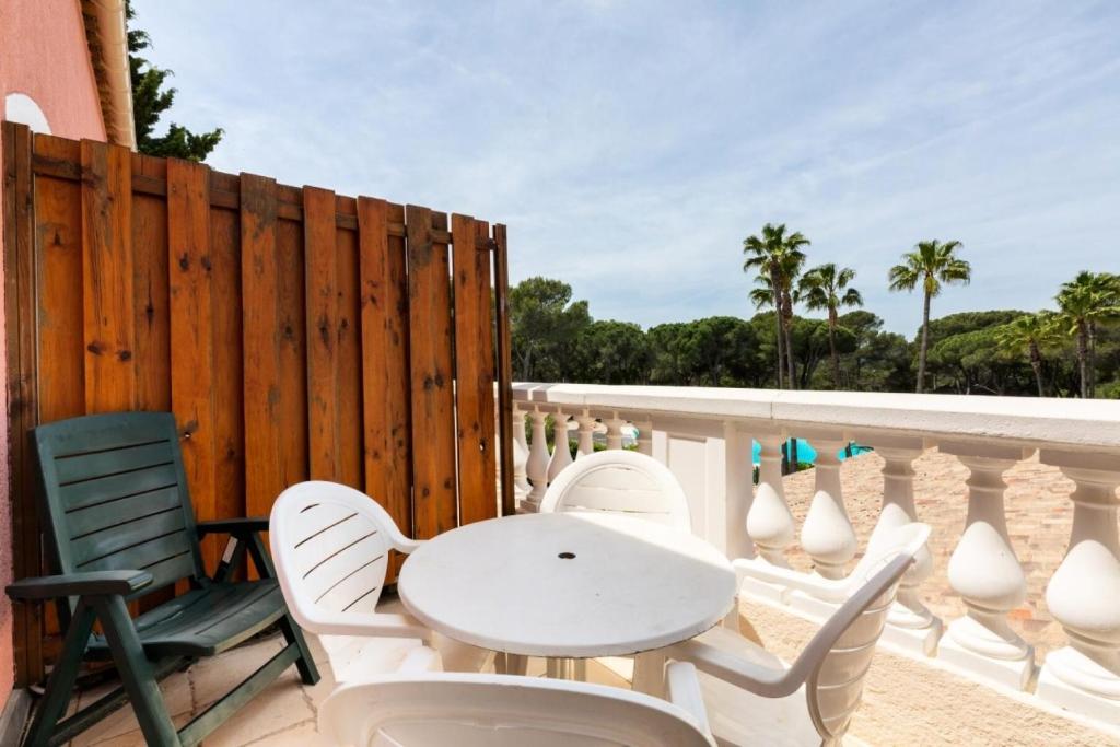 - une table et des chaises blanches sur un balcon donnant sur la plage dans l'établissement Résidence Saint-Raphaël Valescure - maeva Home - 2 Pièces 4 Personnes Sélection MAE-1752, à Valescure