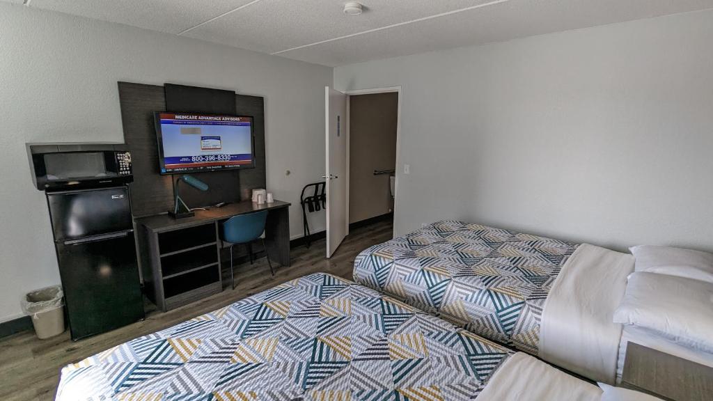 ein Hotelzimmer mit 2 Betten und einem Flachbild-TV in der Unterkunft Motel 6-Leominster, MA in Leominster