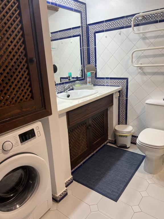 a bathroom with a sink and a washing machine at Casa al mare Aldea in Torrevieja