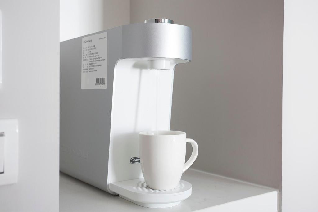 a coffee machine with a cup on a counter at Manho Hotel in Taichung