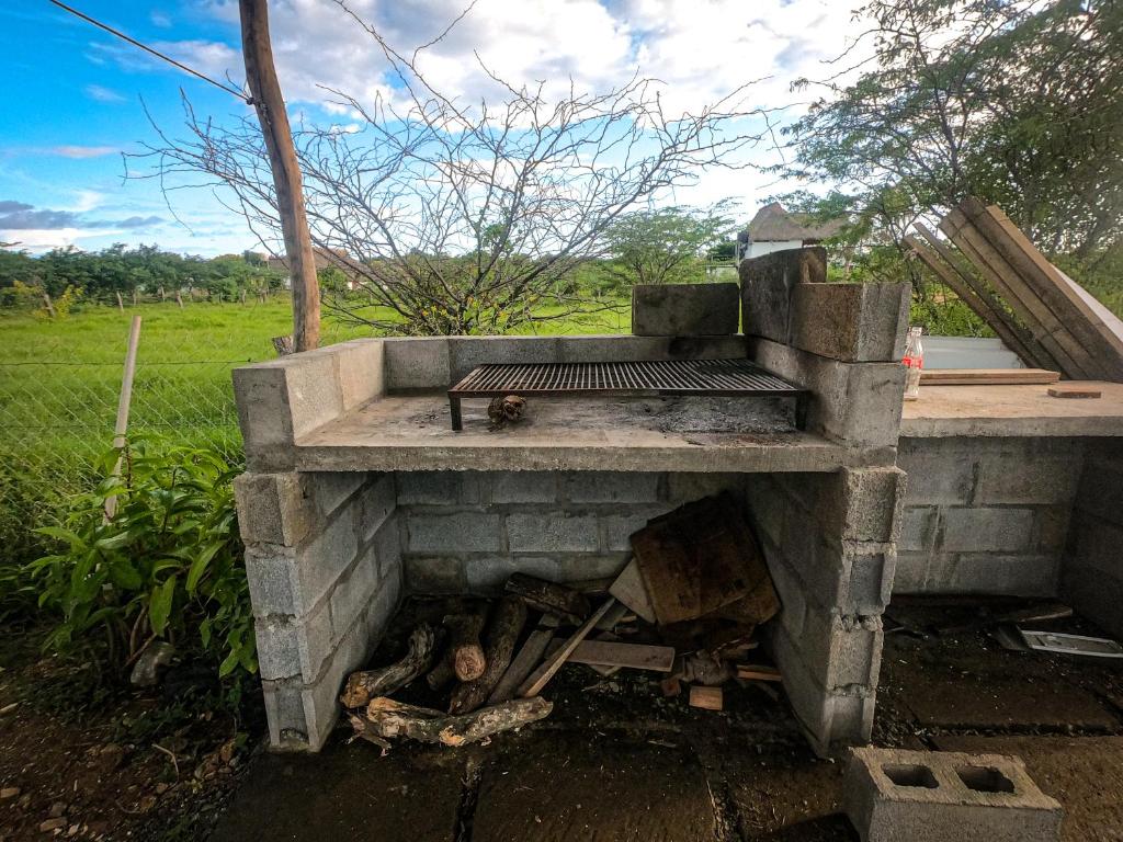 an outdoor grill with a bench on top of it at Low Tide - Popoyo Aparts in Popoyo