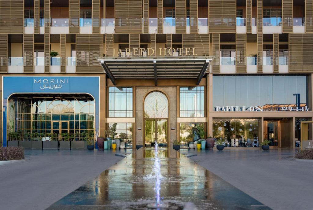 a building with a fountain in the middle of a mall at Jareed Hotel Riyadh in Riyadh