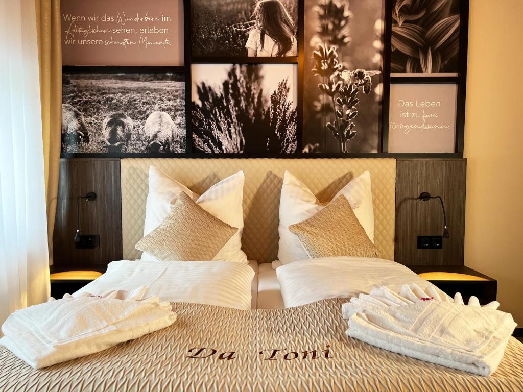 a bedroom with a bed with two towels on it at Hotel Da Toni in Neuenkirchen