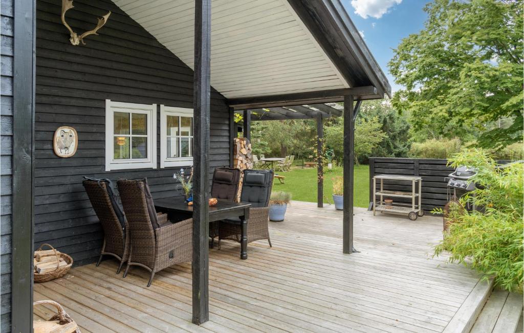 a patio with a table and chairs on a deck at Beautiful Home In Vig With Wifi in Vig