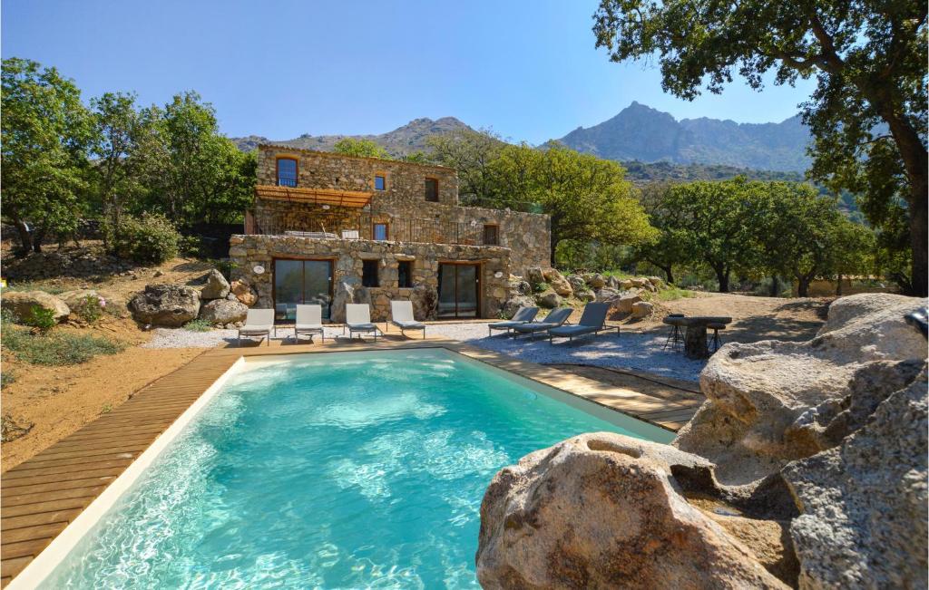 a swimming pool in front of a house with mountains at Awesome Home In Feliceto With House A Mountain View in Feliceto