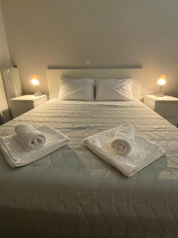 ein weißes Bett mit zwei Handtüchern darüber in der Unterkunft Elia's boutique apartment in Sparta