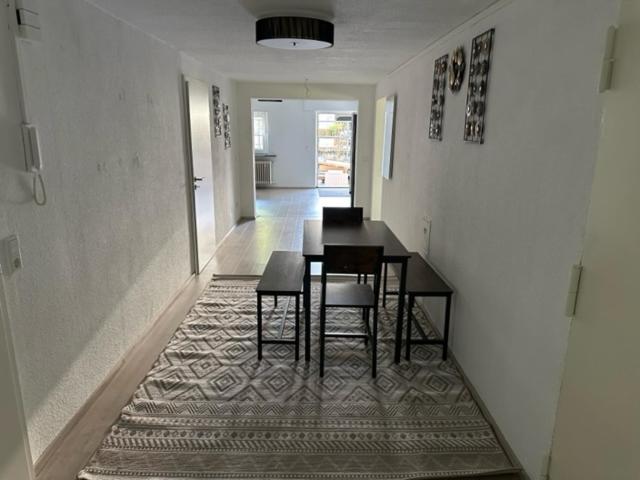 a dining room with a table and chairs on a rug at L8 Street - Leimen - Basement floor in Leimen