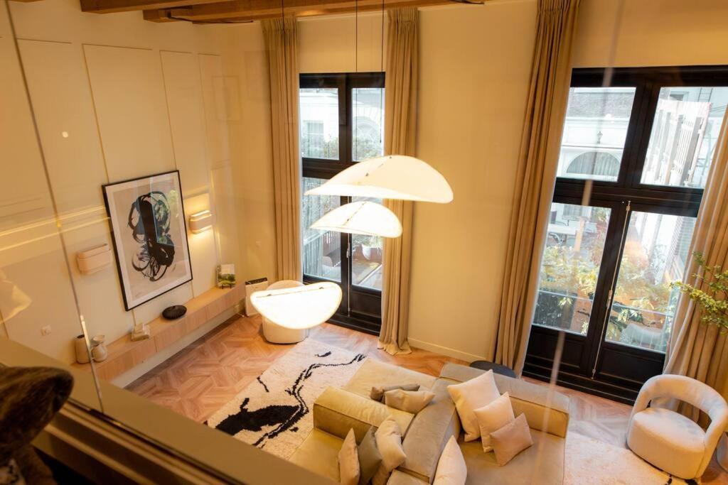 a living room with a couch and a table at Newly renovated luxurious 200 SQM loft in city centre in Amsterdam