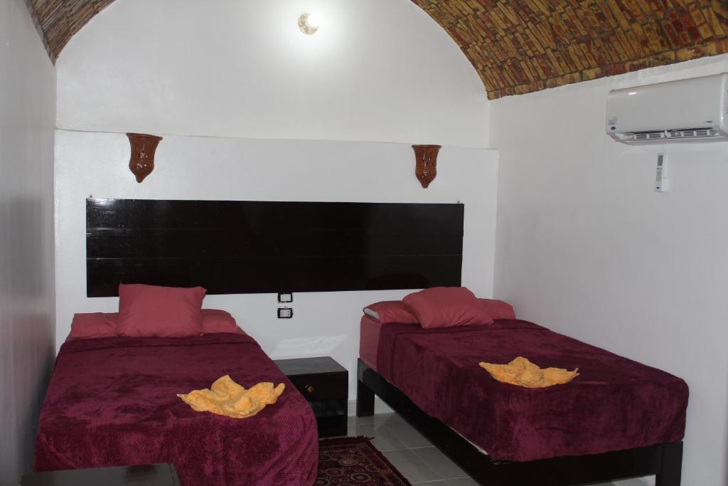 A bed or beds in a room at Ajwa Guest House