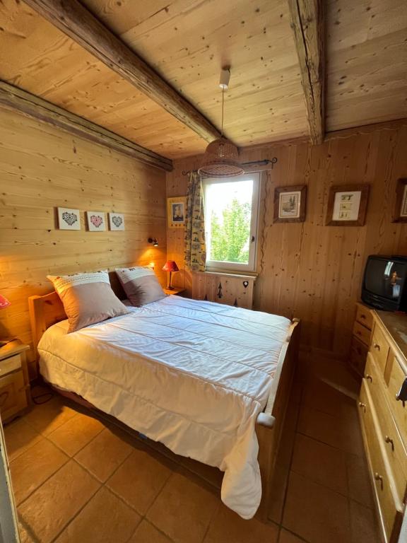 a bedroom with a bed in a wooden room at Appartement cosy, esprit chalet avec jolie vue in Saint-Gervais-les-Bains