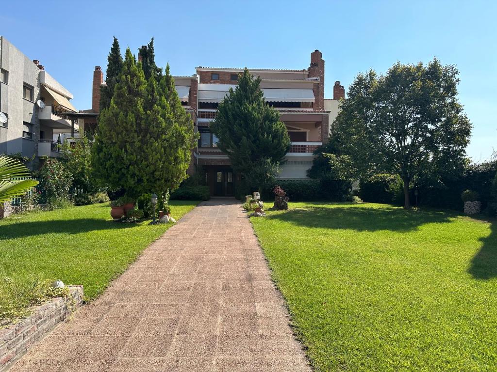 une maison avec des arbres et une allée en briques dans l'établissement Villa Reina, à Alexandroúpolis