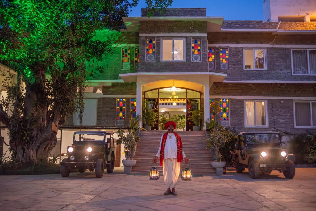 a woman walking in front of a house at Ranakpur Safari Resort in Sādri