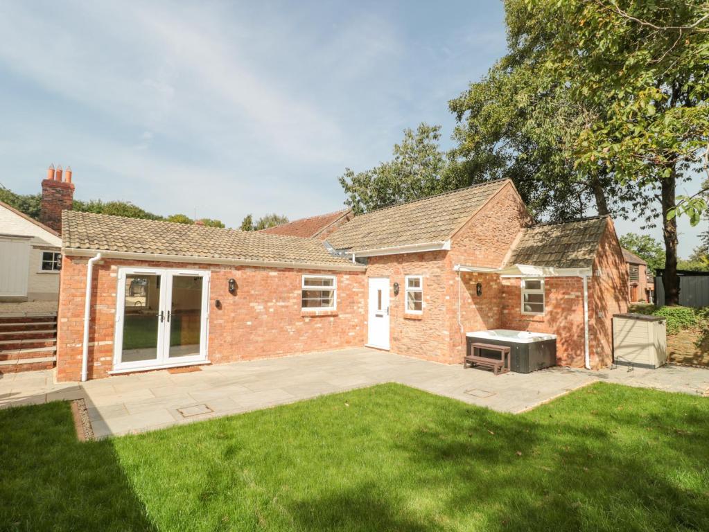 a brick house with a lawn in the yard at The Nest in Bridgwater