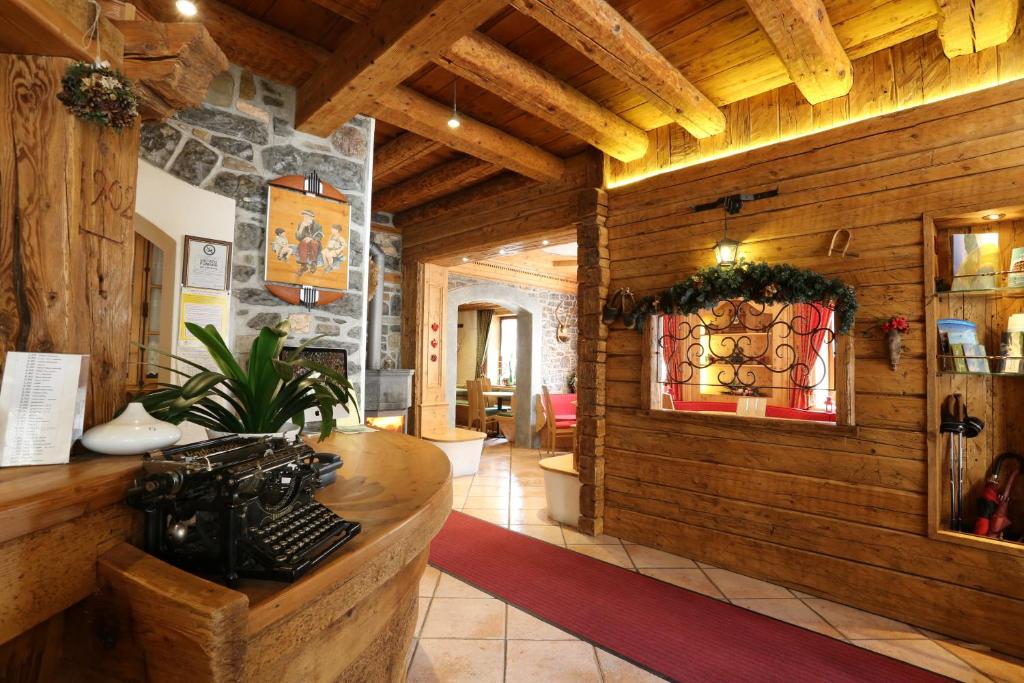 a room with wooden walls and a counter with an old camera at Albergo Centrale in Forni di Sopra