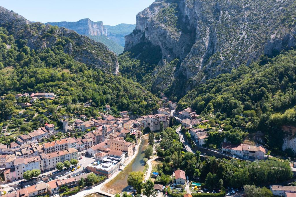 an aerial view of a village in the mountains at Hôtel du Musée de l'Eau in Pont-en-Royans