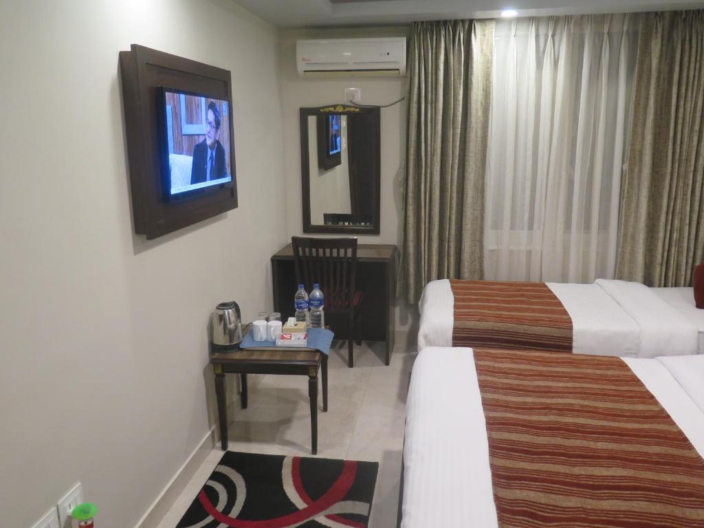 Postel nebo postele na pokoji v ubytování Hotel Pipal Tree