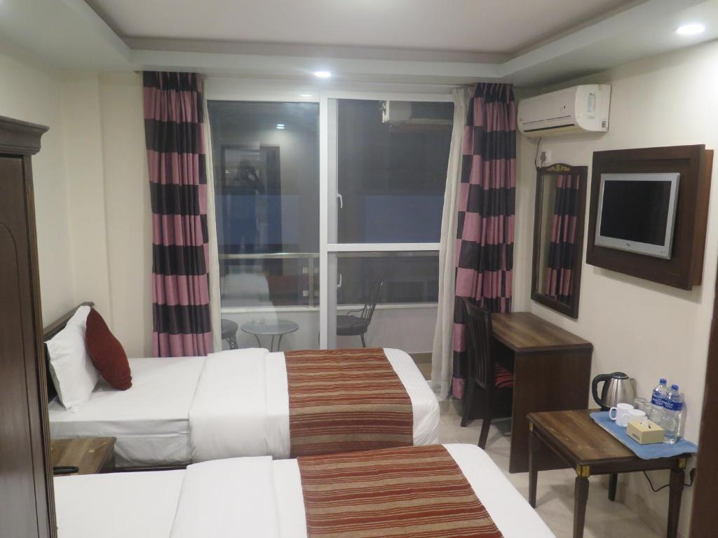 Postel nebo postele na pokoji v ubytování Hotel Pipal Tree