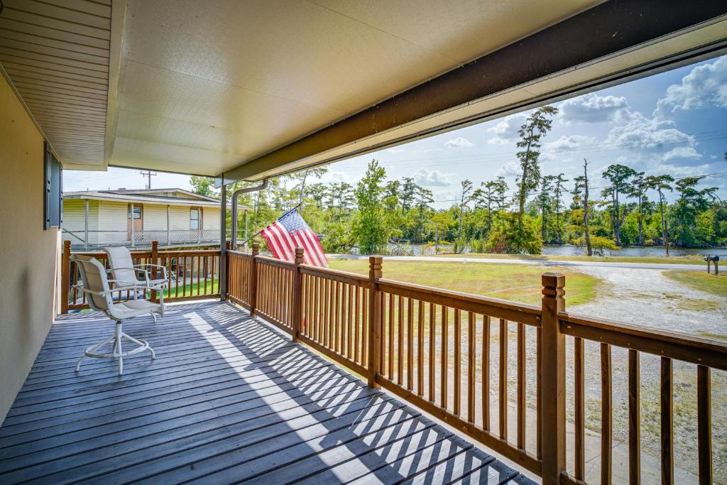 a balcony with an american flag and a chair at Louisiana Abode - Balcony, Pool Table and Lake Views in Lake Charles