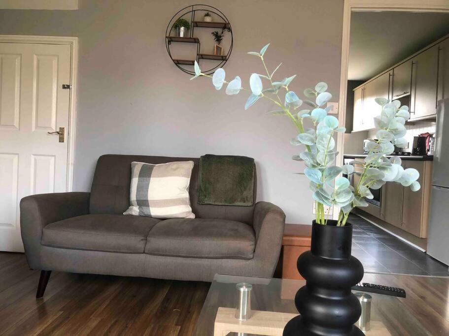 a living room with a couch and a table at Greyfriar House in Brumby