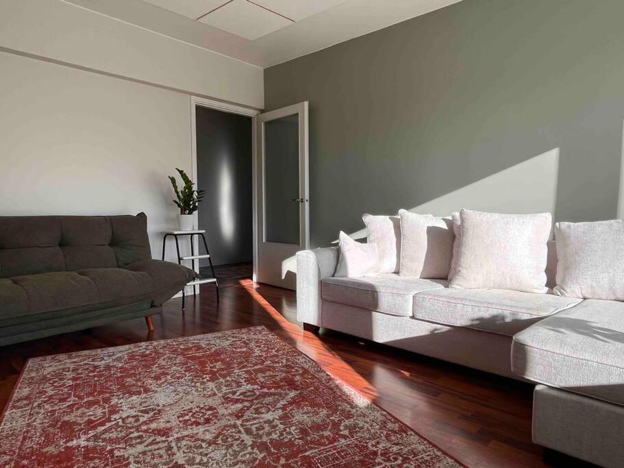 a living room with a couch and a rug at A stylish, newly decorated home! in Raahe