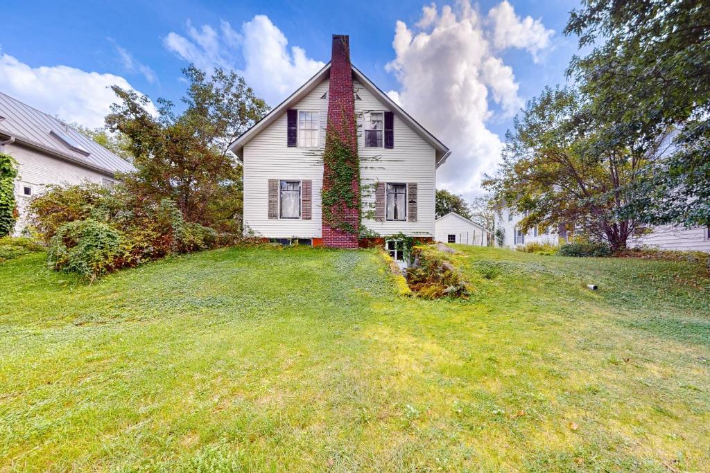 a white house with ivy growing on the side of it at The Farmhouse Back House in Montpelier