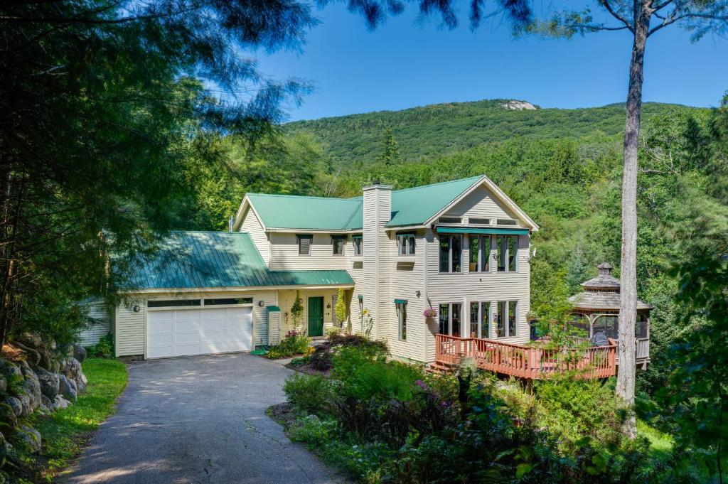 a white house with a green roof and a driveway at Charming Thornton Escape with Sauna and Gazebo! in Thornton