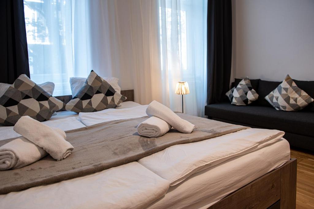 a large bed with pillows on it in a room at My city apartment vienna- one Bedroom in Vienna