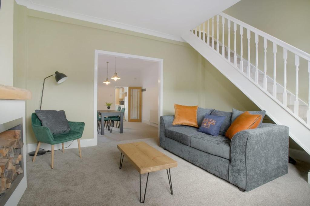 a living room with a couch and a staircase at Lovely 2-Bedroom Home in Langley Park, Sleeps 4 in Durham