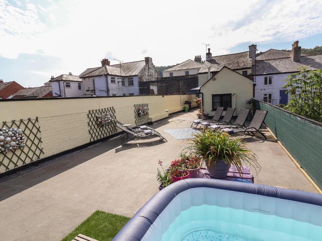 a balcony with a swimming pool and a house at The Funky Flat in Holywell