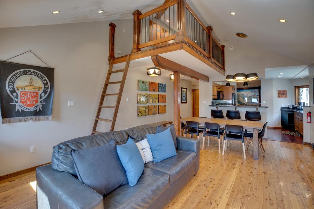 a living room with a couch and a loft at Bright Downtown Telluride Condo - Steps to Lift! in Telluride