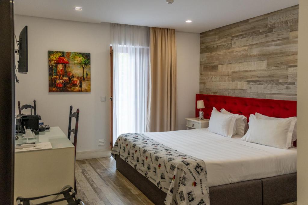 Cama ou camas em um quarto em Art'Otel Barcelos