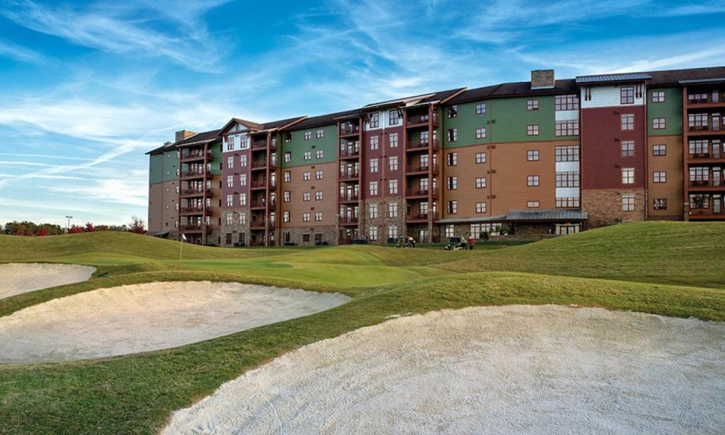 a golf course with a large apartment building in the background at Great Smokies Lodge Resort 2BR in Sevierville