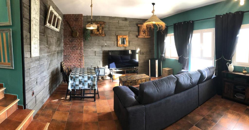 a living room with a couch and a fireplace at Sierra Nevada Galatino 22E in Sierra Nevada