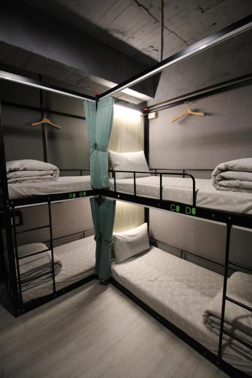Postel nebo postele na pokoji v ubytování Backpackers Hostel - Ximen