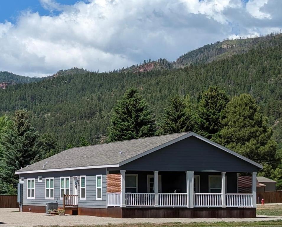a house with a mountain in the background at 3bed2bath With Creek And Open Spaces in Durango
