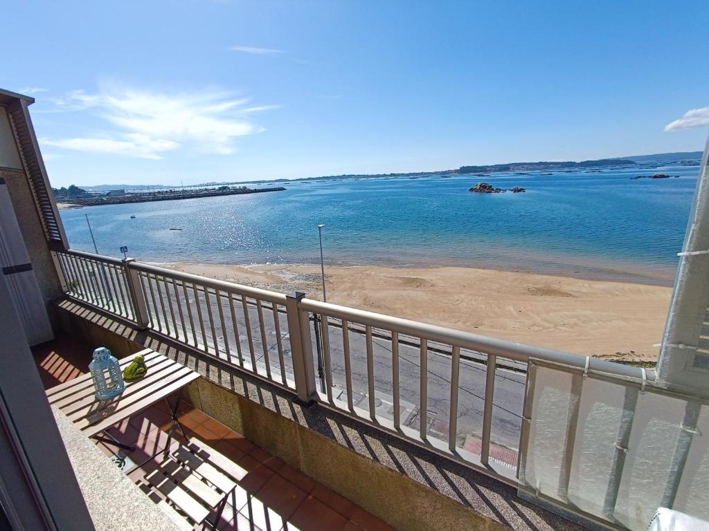 uma varanda com vista para a praia e para o oceano em Mirador Mar de Castelao, 1ª línea de playa urbana em Vilanova de Arousa