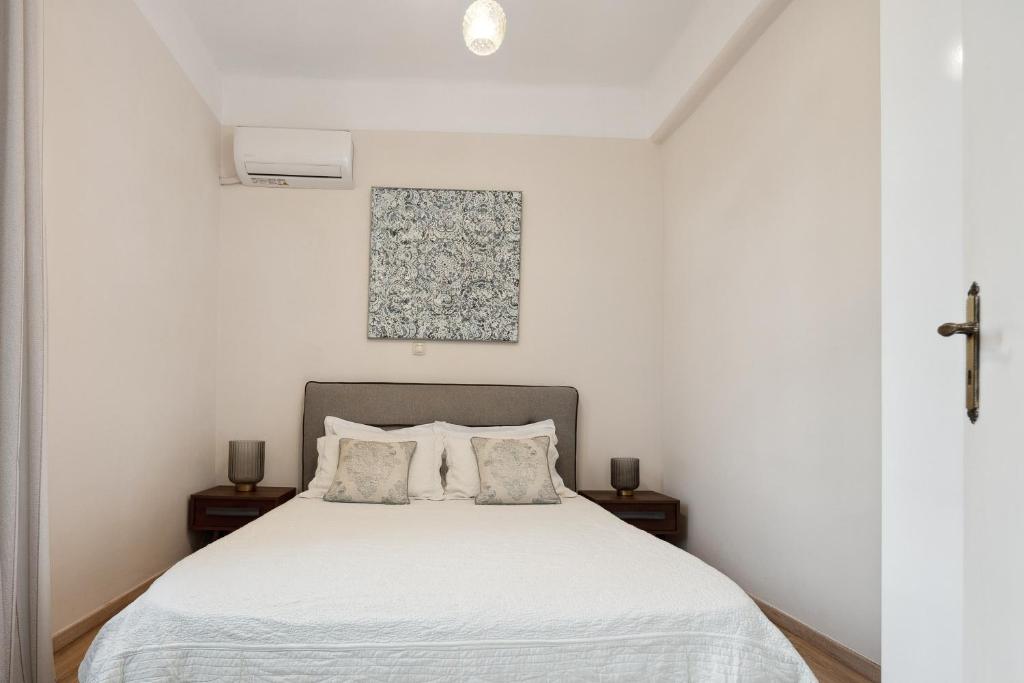 a bedroom with a white bed with two pillows at Casa Di Sofia in Rethymno Town