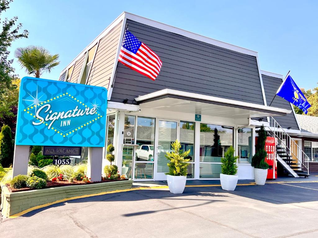 an entrance to a store with an american flag at Signature Inn Eugene in Eugene