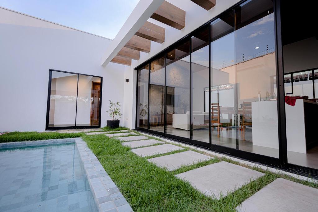 an exterior view of a house with a swimming pool and grass at Alter do Chão - Alter Casa Cocar in Alter do Chao